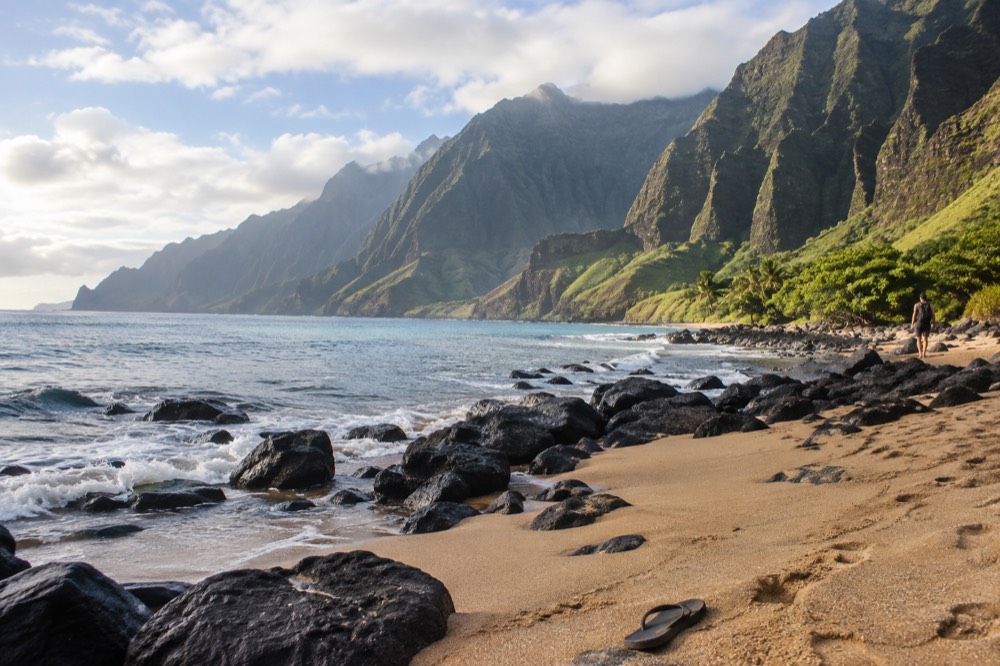 Calm morning sea along a rugged coastline with tall cliffs and green valleys