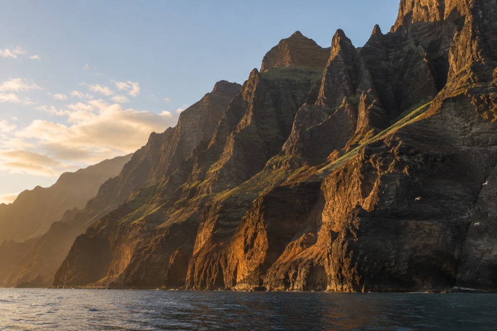 Sunset light on the Napali cliffs seen from the water off Kauai
