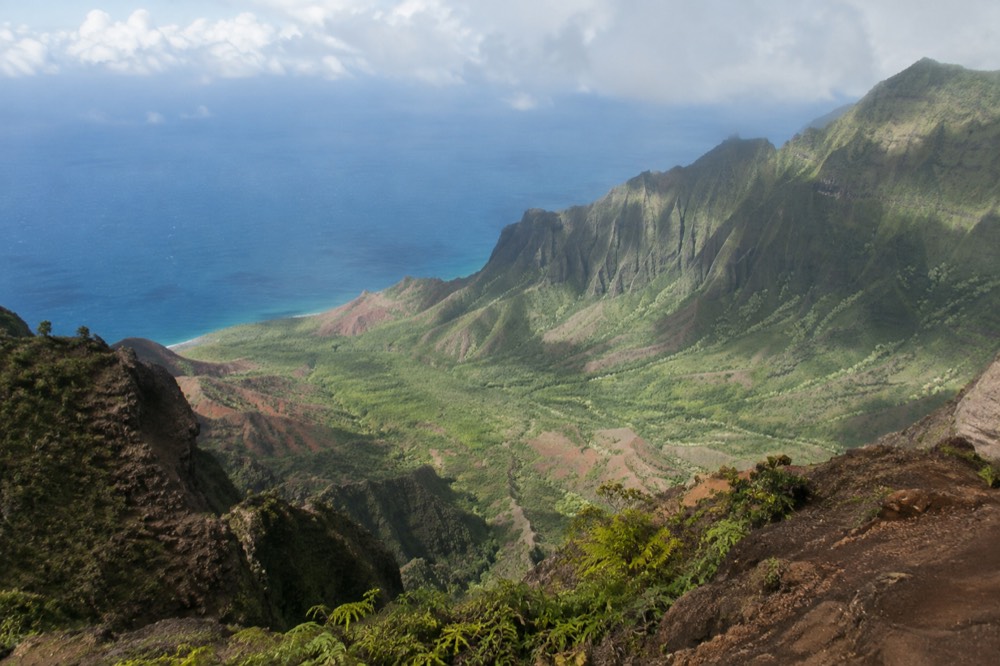 Deep green valleys and thin ridges of the Napali Coast seen from high above